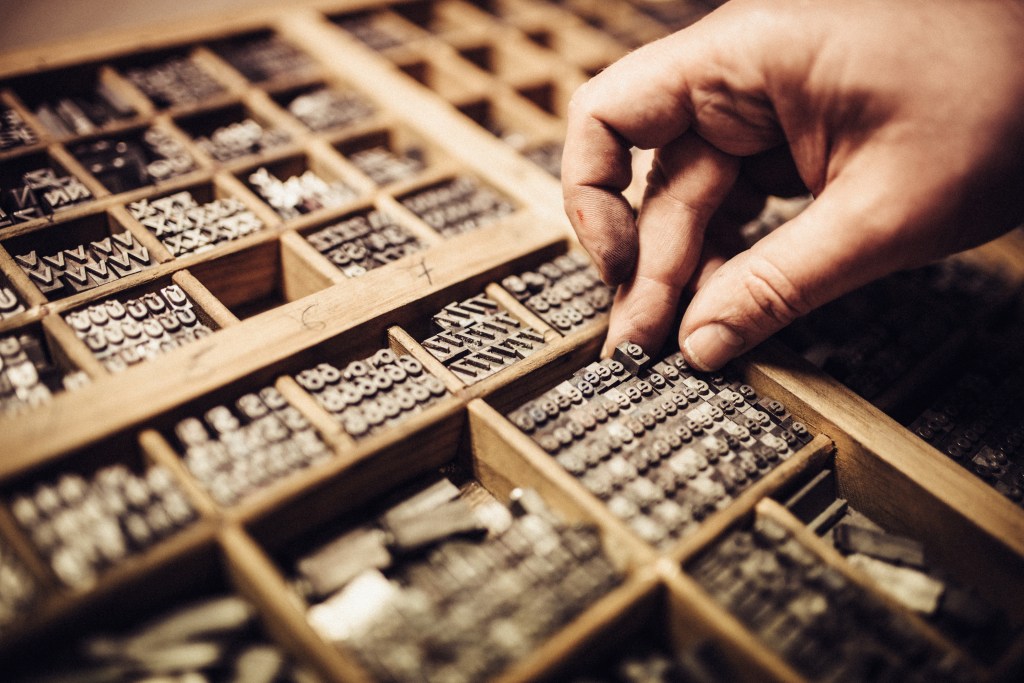 Artisan composing movable type for Letterpress Printing.